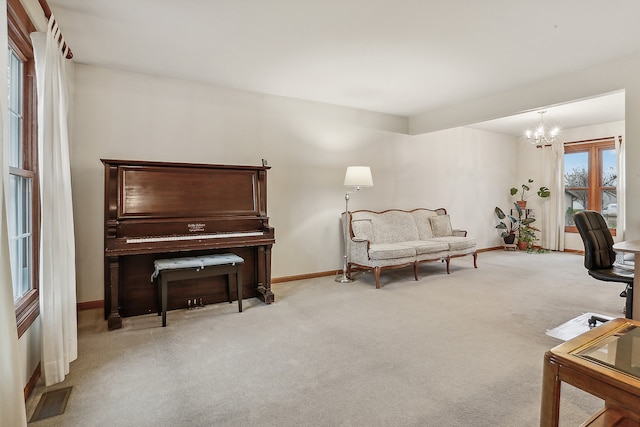 interior space featuring light colored carpet and a notable chandelier