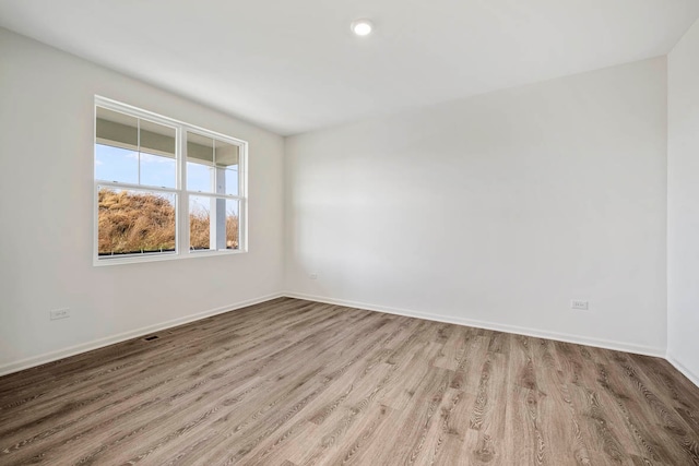 empty room with light hardwood / wood-style floors