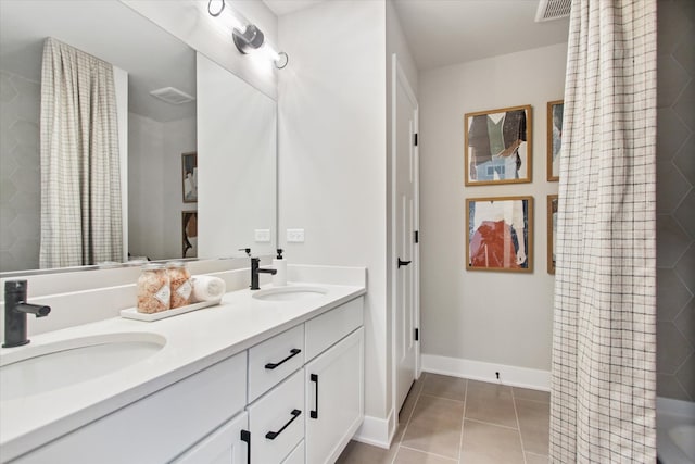 bathroom with vanity and tile patterned flooring