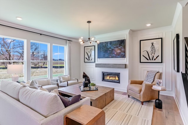 living room featuring an inviting chandelier and light wood-type flooring