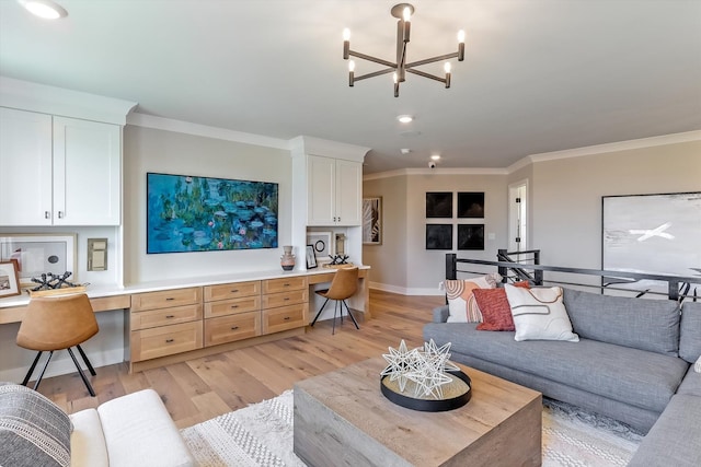 living room with an inviting chandelier, built in desk, ornamental molding, and light hardwood / wood-style flooring