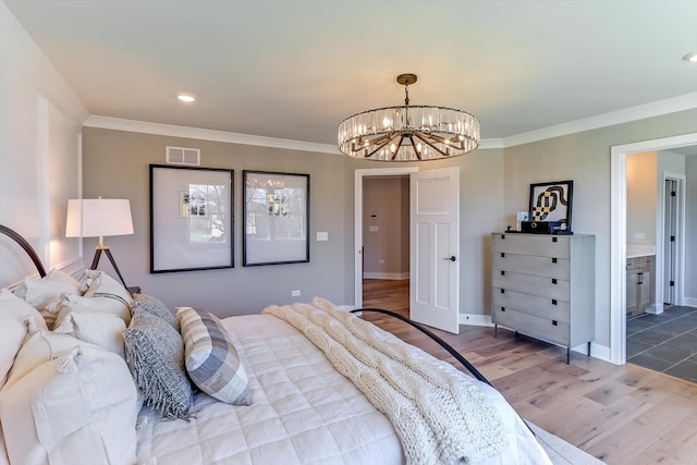 bedroom with wood-type flooring, ornamental molding, and ensuite bath