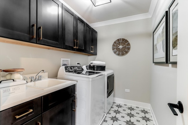 clothes washing area featuring cabinets, washing machine and dryer, sink, and ornamental molding