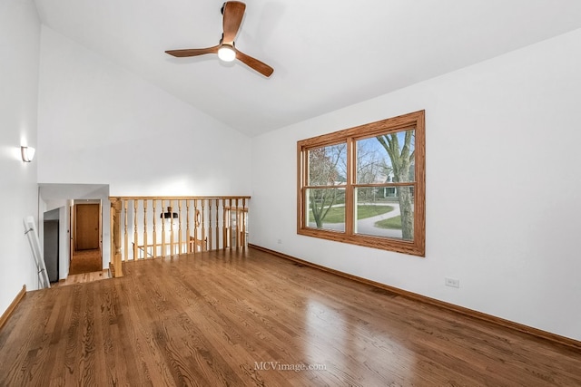 additional living space with hardwood / wood-style floors, vaulted ceiling, and ceiling fan