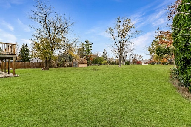 view of yard featuring a storage shed and a wooden deck