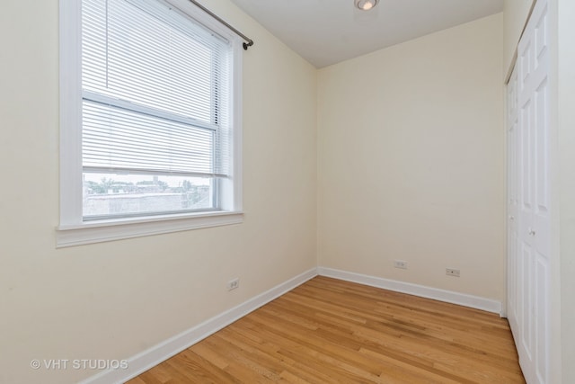 unfurnished bedroom featuring light hardwood / wood-style floors and a closet