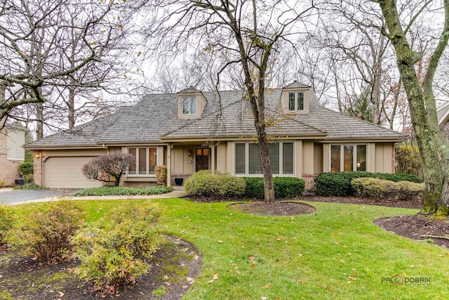 view of front of home with a garage and a front yard