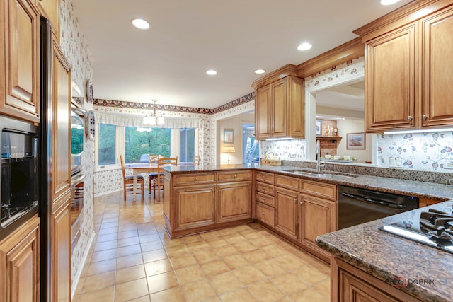 kitchen featuring sink, hanging light fixtures, black dishwasher, a notable chandelier, and kitchen peninsula