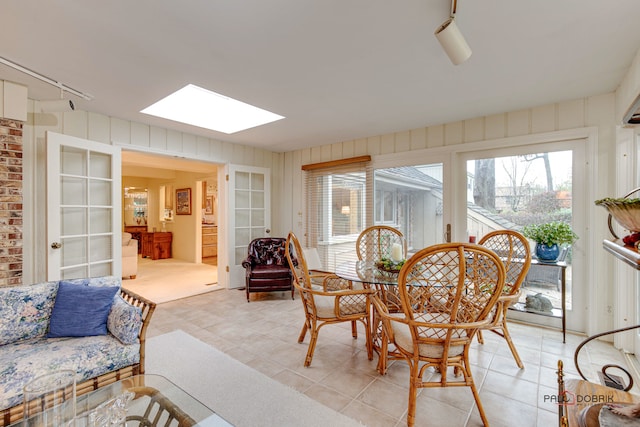 sunroom / solarium with french doors and a skylight