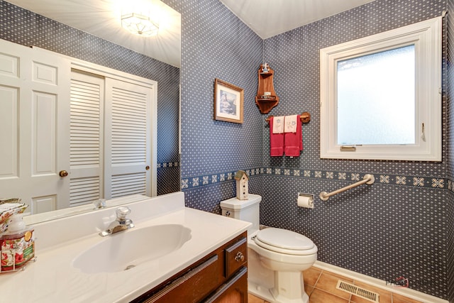 bathroom featuring tile patterned flooring, vanity, and toilet