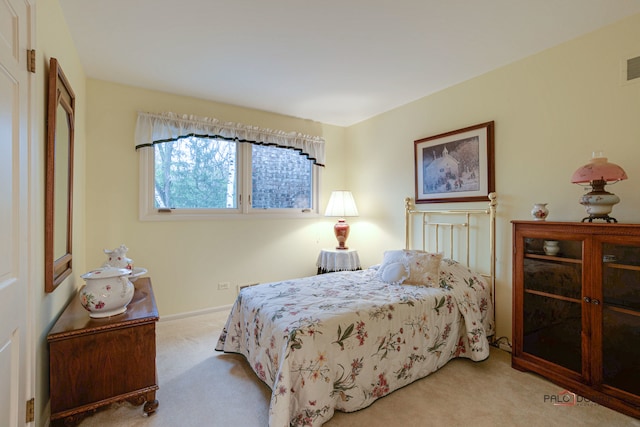 bedroom featuring light colored carpet