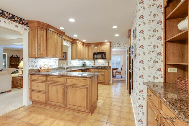 kitchen featuring dark stone countertops, sink, light tile patterned floors, and stainless steel gas cooktop