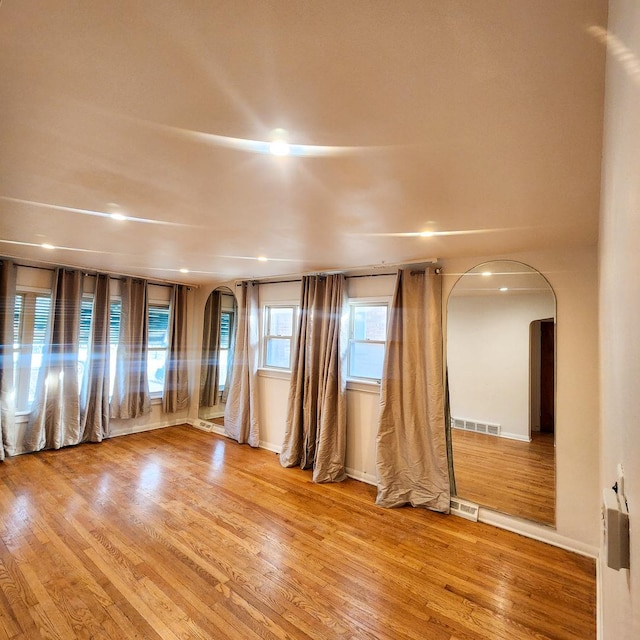 empty room with hardwood / wood-style floors