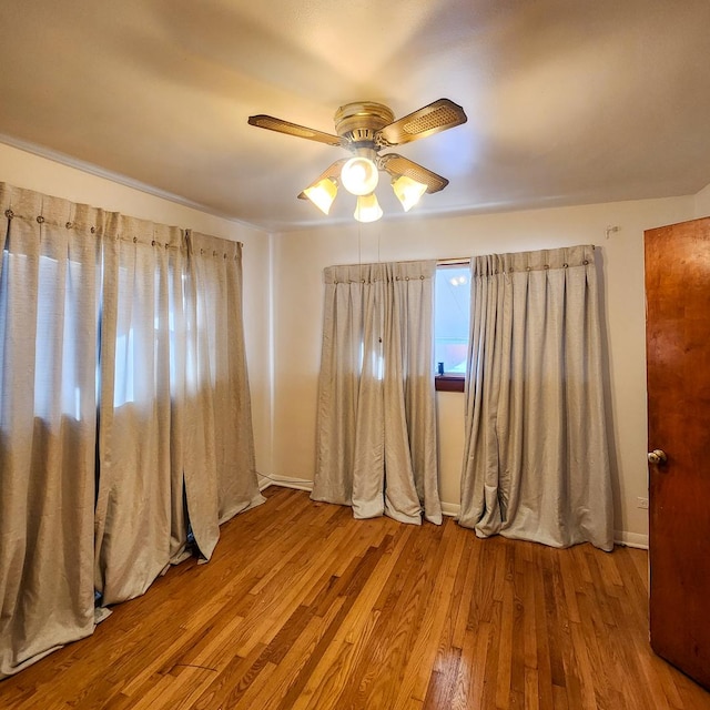 unfurnished room featuring ceiling fan and light hardwood / wood-style flooring