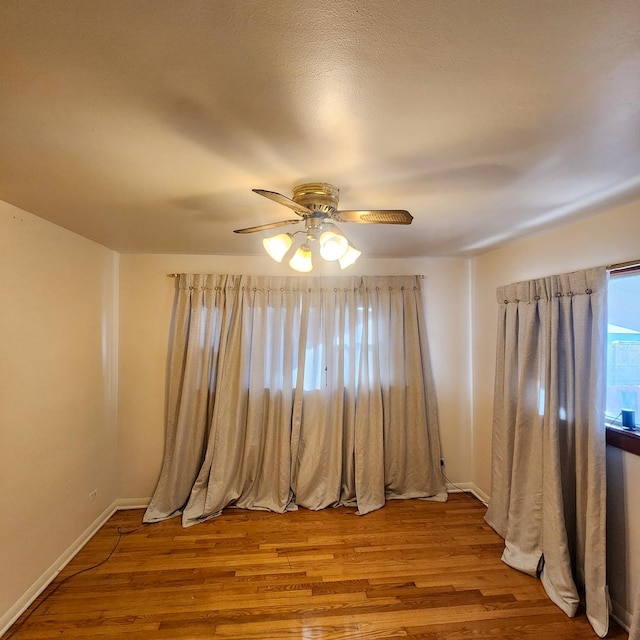 unfurnished room with ceiling fan and light wood-type flooring