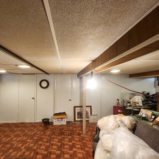 basement with dark parquet flooring