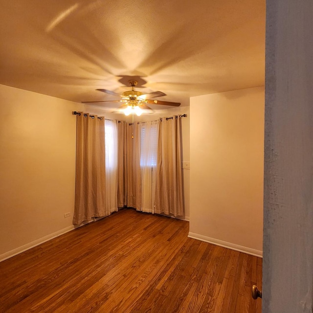 spare room with ceiling fan and hardwood / wood-style floors