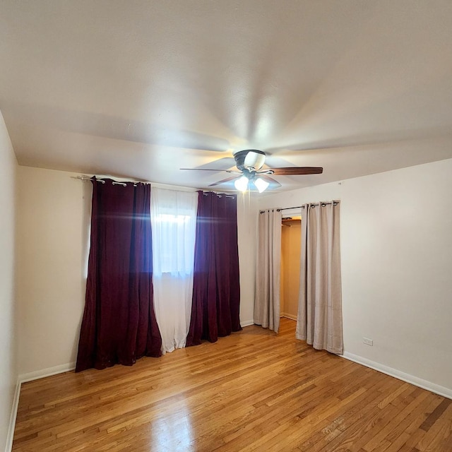 unfurnished room featuring ceiling fan and light wood-type flooring