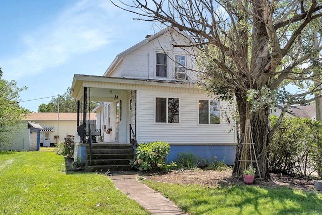 view of front of home with a front yard and covered porch