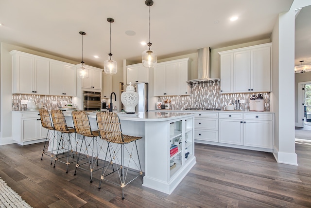 kitchen with wall chimney exhaust hood and white cabinets