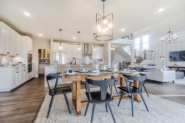 dining area featuring dark hardwood / wood-style flooring, sink, and an inviting chandelier