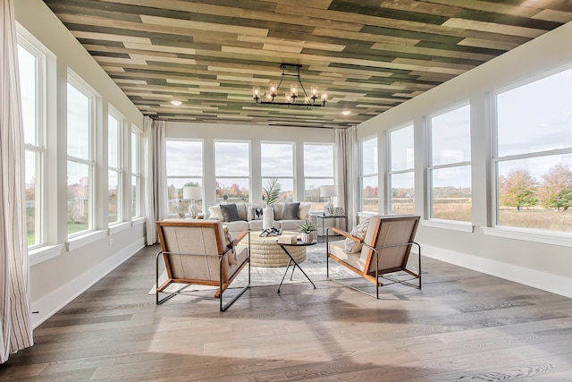 sunroom / solarium featuring a chandelier and a healthy amount of sunlight