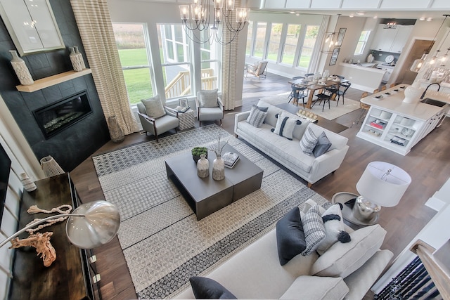 living room with dark wood-type flooring and a tile fireplace