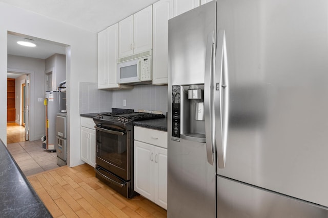 kitchen featuring backsplash, white cabinetry, stainless steel fridge with ice dispenser, and black gas range oven