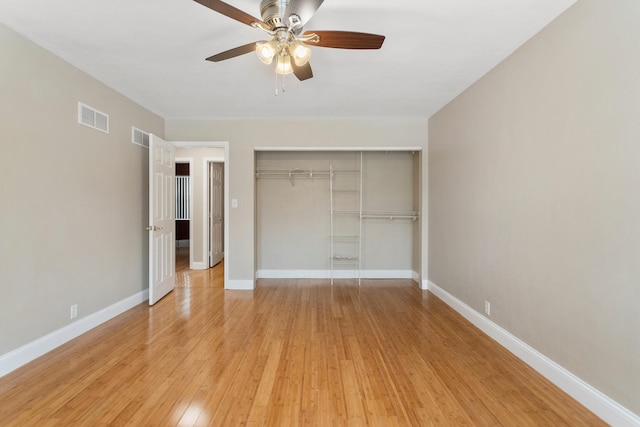 unfurnished bedroom with a closet, light hardwood / wood-style flooring, and ceiling fan