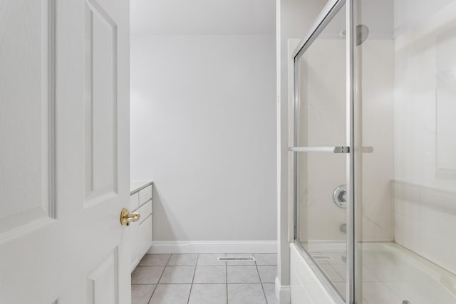 bathroom featuring tile patterned floors, vanity, and a shower with door