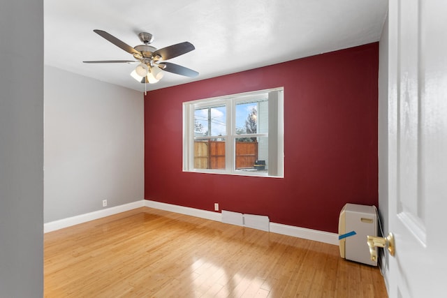 empty room featuring hardwood / wood-style floors and ceiling fan