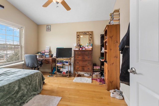 bedroom featuring hardwood / wood-style floors, ceiling fan, and vaulted ceiling