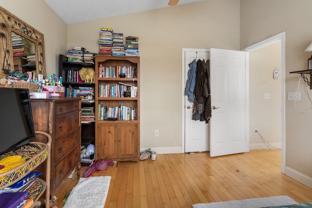 miscellaneous room with light hardwood / wood-style floors and vaulted ceiling