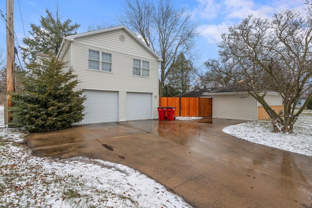 view of snowy exterior featuring a garage