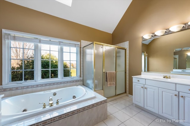 full bath featuring vaulted ceiling, a shower stall, vanity, a whirlpool tub, and tile patterned floors