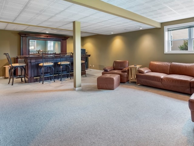 carpeted living room featuring recessed lighting, baseboards, and a bar