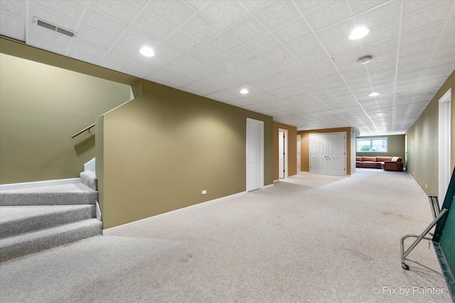 basement with stairway, carpet flooring, visible vents, and recessed lighting