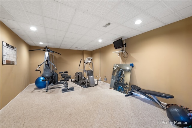 workout area featuring a drop ceiling, recessed lighting, visible vents, baseboards, and carpet