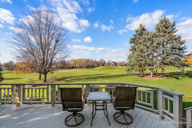 wooden deck featuring a lawn