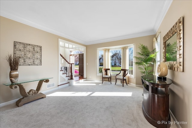 sitting room featuring carpet floors, visible vents, baseboards, ornamental molding, and stairway