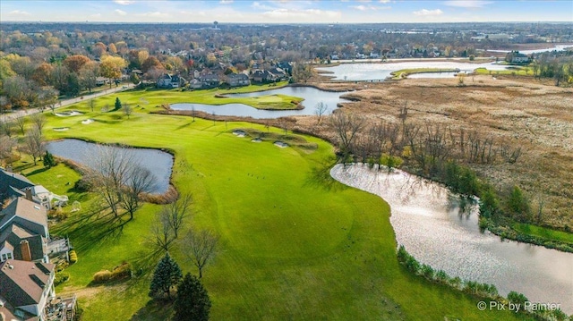 birds eye view of property featuring golf course view and a water view