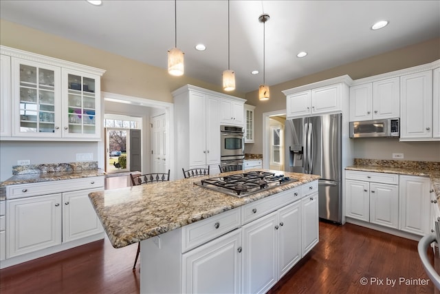 kitchen featuring appliances with stainless steel finishes, white cabinetry, and a center island