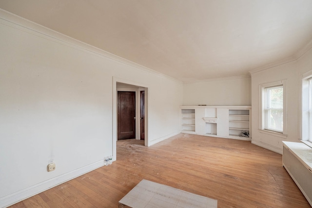 unfurnished living room with light wood-type flooring, radiator, and ornamental molding