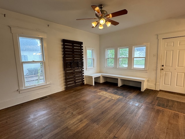 interior space featuring ceiling fan and dark hardwood / wood-style flooring