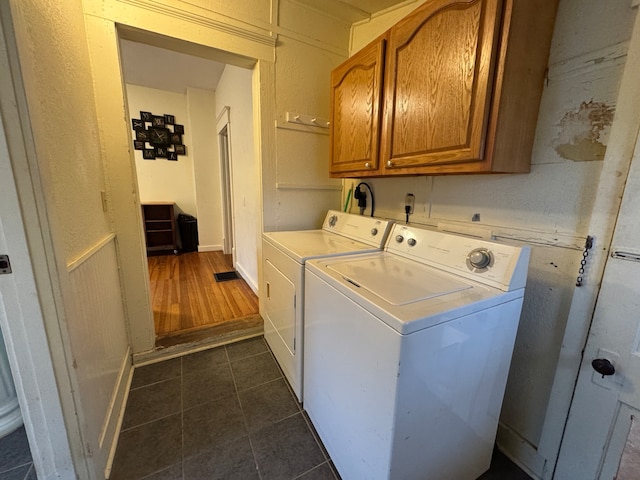 washroom featuring cabinets, separate washer and dryer, and dark wood-type flooring