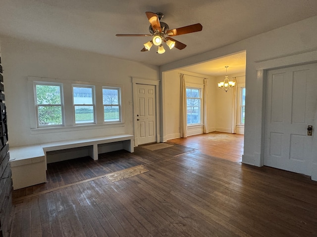 interior space featuring dark hardwood / wood-style flooring and ceiling fan with notable chandelier