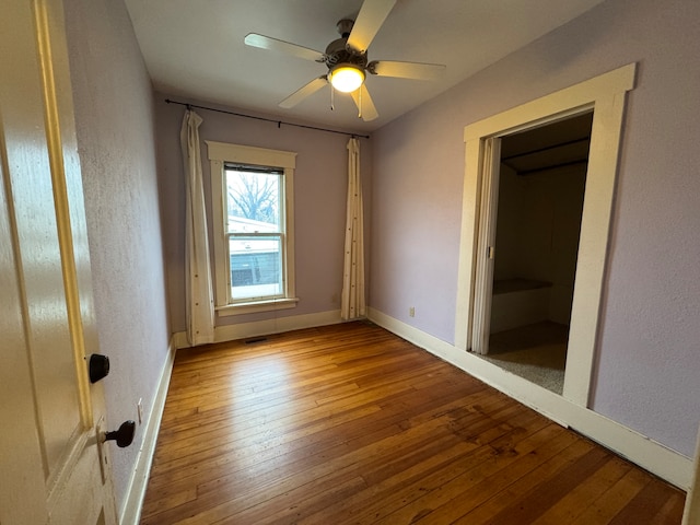 spare room with ceiling fan and light wood-type flooring