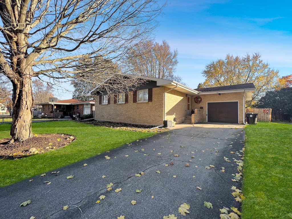 view of front of property with a front lawn and a garage