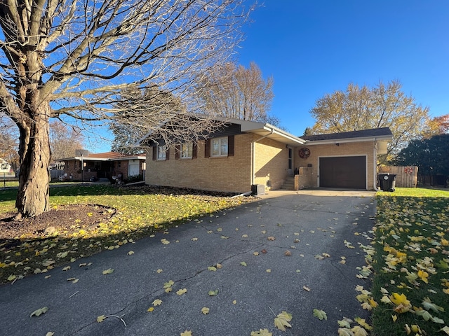 view of front of home with a garage and a front lawn