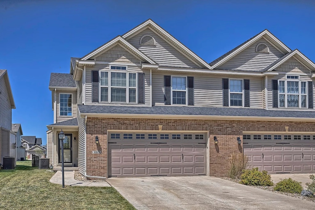 view of front of property with central AC and a garage